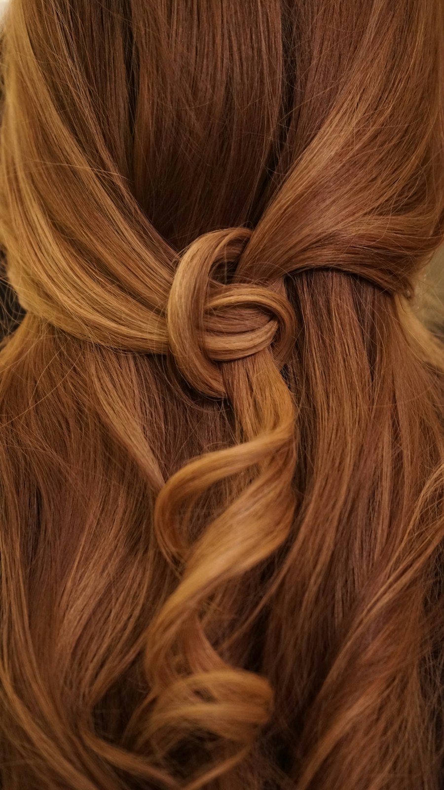 Rich golden hair with a delicate knotted half-up style
