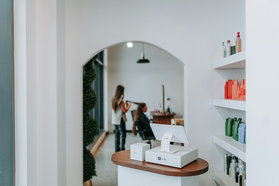 A bright salon with a stylist caring for a guest